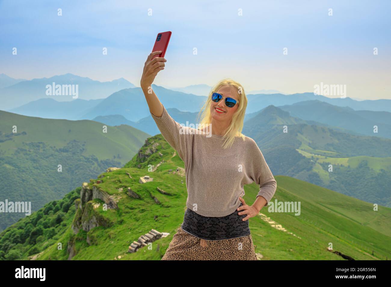 Femme touristique prenant des photos de selfie sur les gratte-ciel de Monte Generoso ou sur le mont Calvagione suisse du canton du Tessin. En haut de la gare de Cog à Mendrisio Banque D'Images