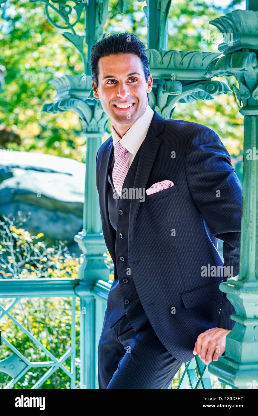 Homme d'âge moyen, portant trois pièces de costume bleu foncé, cravate rose  à motifs, chemise blanche, sourire Photo Stock - Alamy
