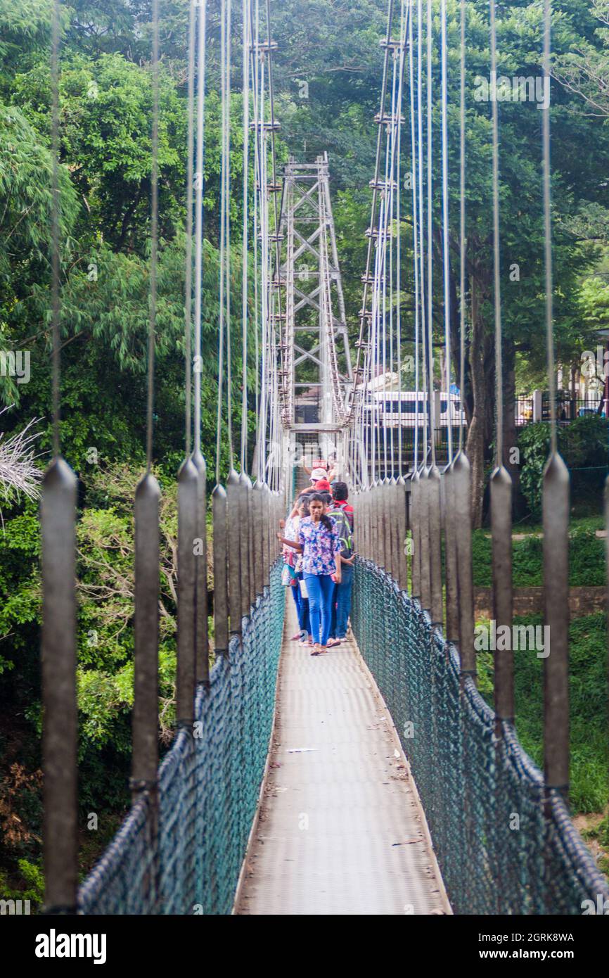 KANDY, SRI LANKA - 18 JUILLET 2016: Personnes à un pont suspendu à pied dans les jardins botaniques royaux de Peradeniya près de Kandy, Sri Lanka Banque D'Images