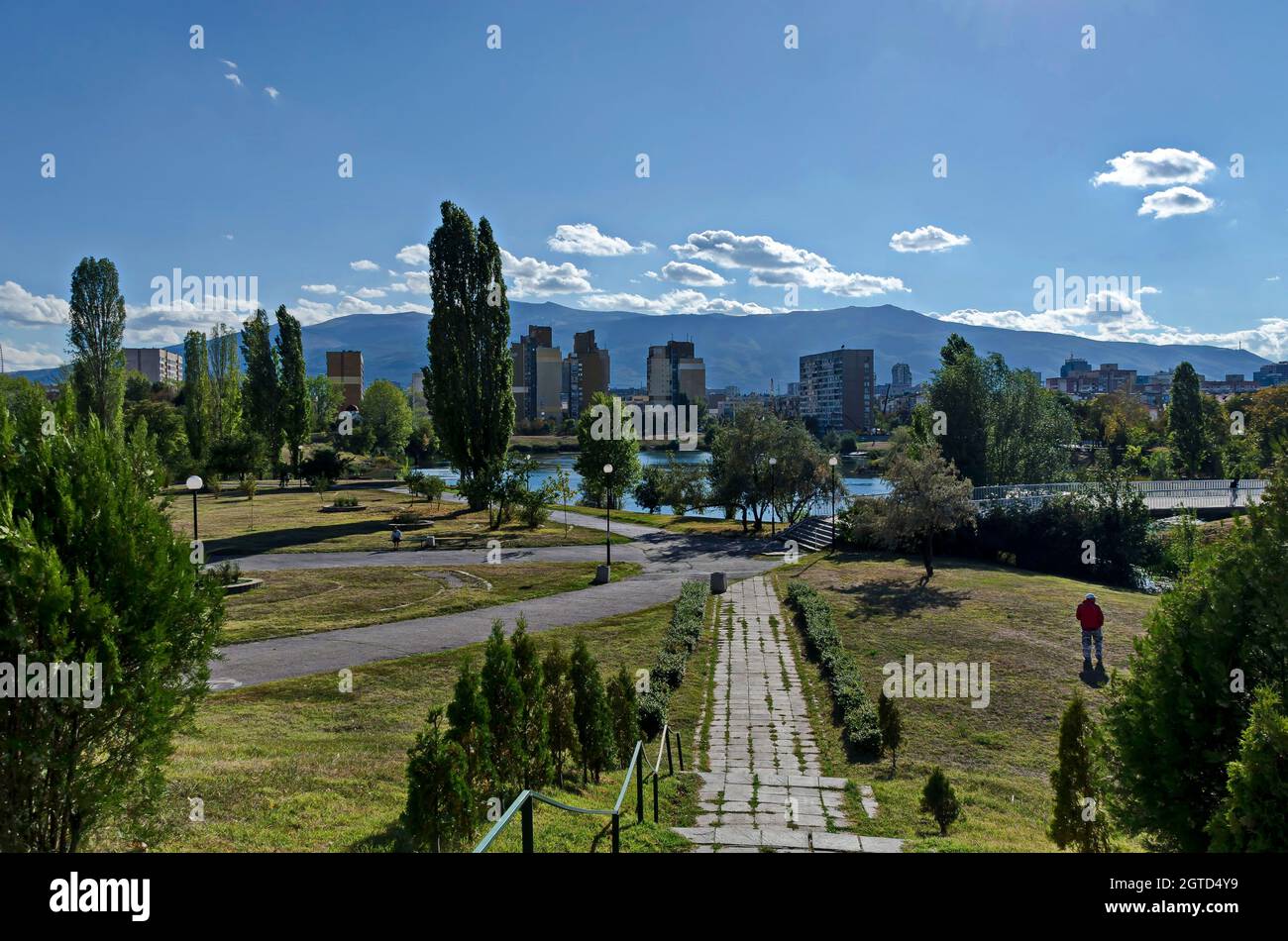 Panorama d'automne d'une partie du quartier au bord du lac avec arbres verts, arbustes et herbe brûlée, Drujba, Sofia, Bulgarie Banque D'Images