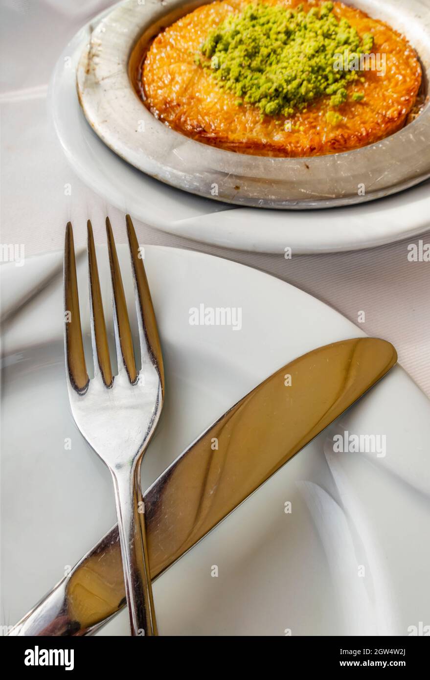 Gros plan prêt à manger turc dessert Kunefe avec assiette, couteau et  fourchette Photo Stock - Alamy