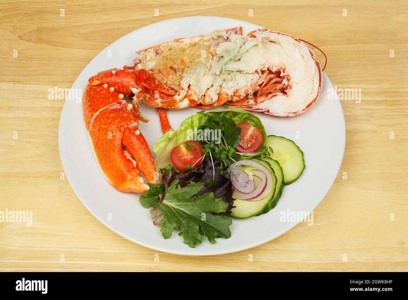 Demi-homard avec salade sur une assiette sur une table en bois Photo Stock  - Alamy
