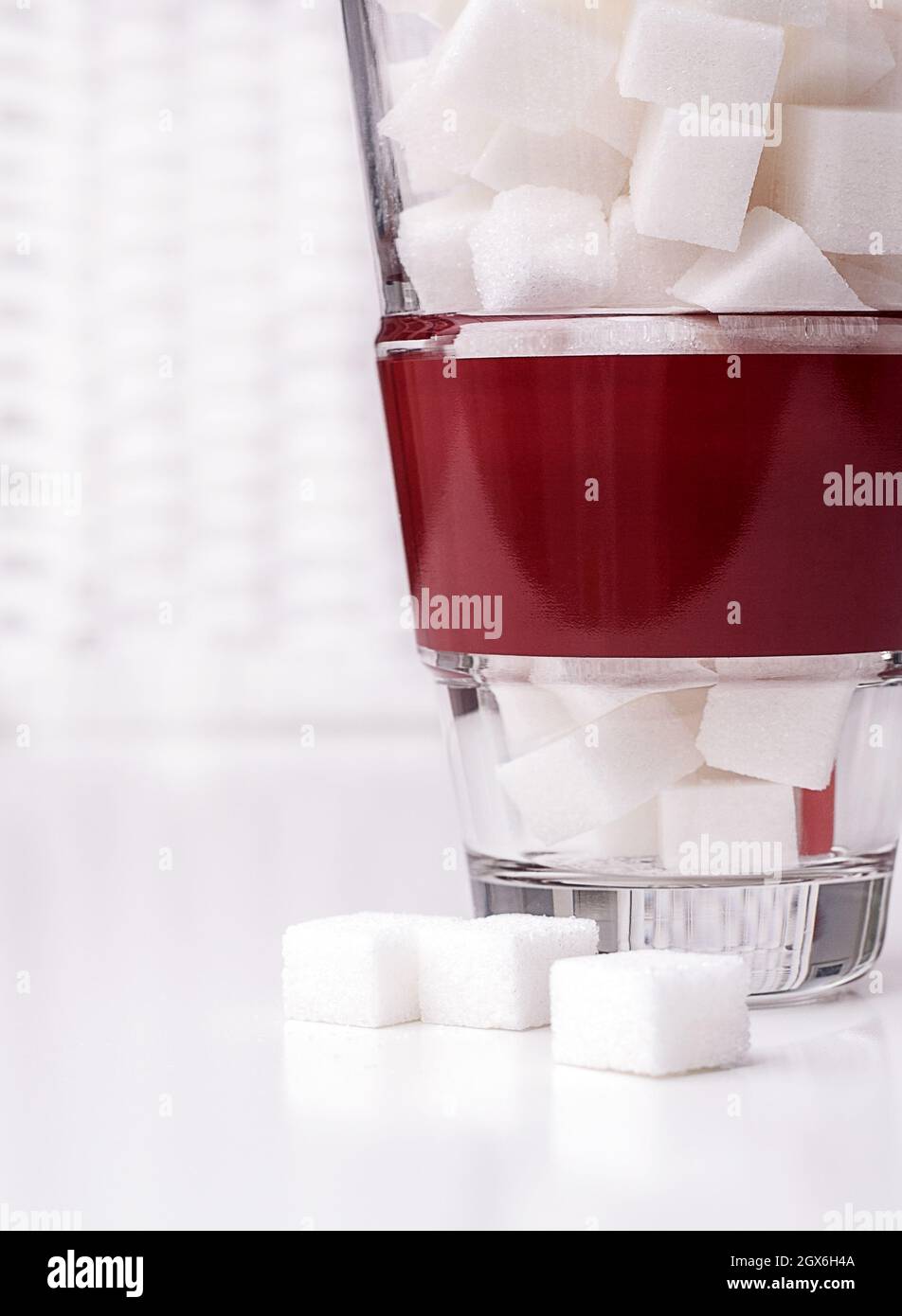 Cubes de sucre en verre avec une bande rouge sur fond blanc Banque D'Images Cubes de sucre en verre avec une bande rouge sur fond blanc Banque D'Images