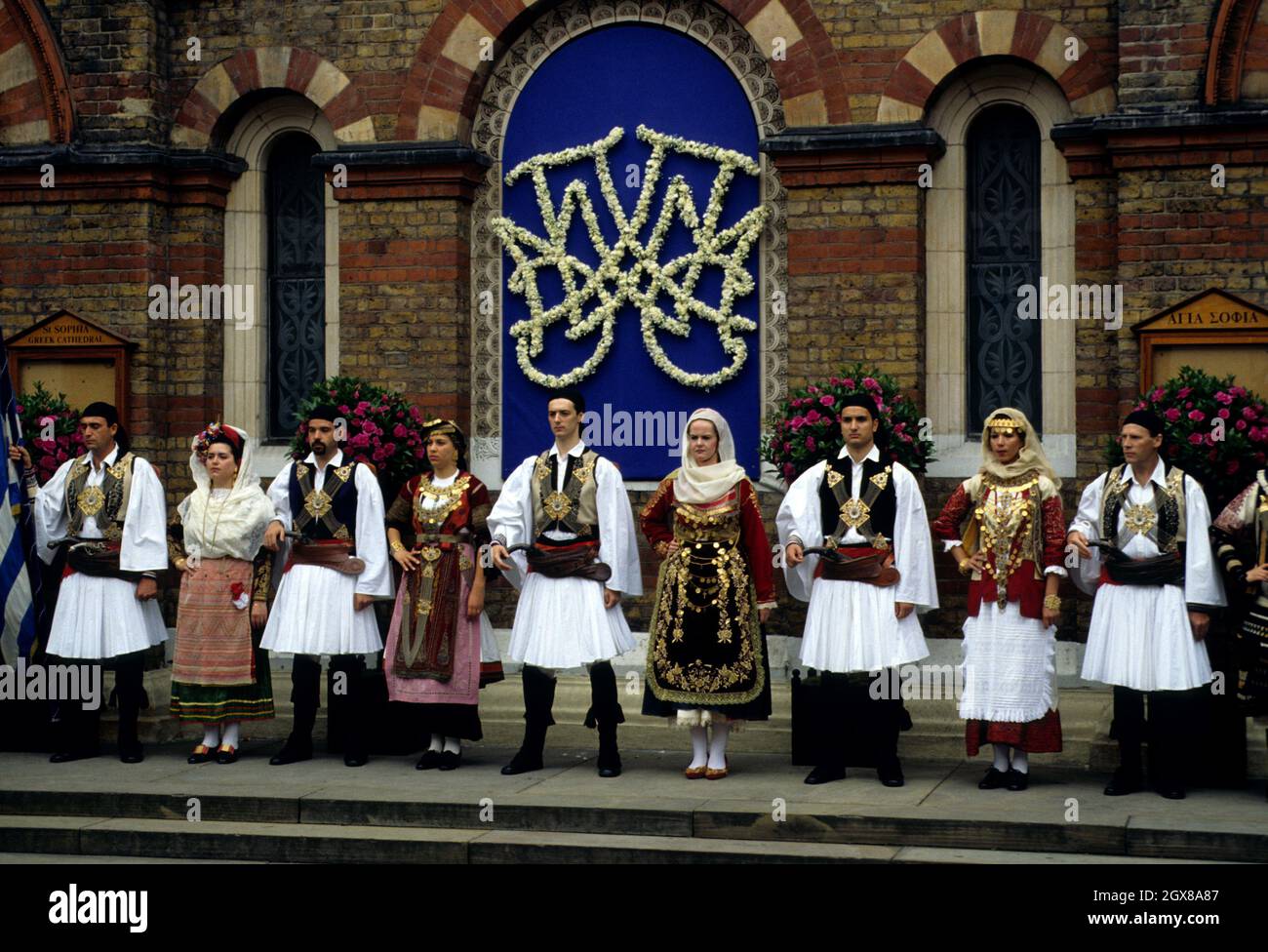 Une troupe de danse grecque traditionnelle se trouve à l'extérieur de la cathédrale Sainte-Sophie, à Londres, après le mariage de Pavlos, prince héritier de Grèce et de Marie-Chantal Miller Banque D'Images