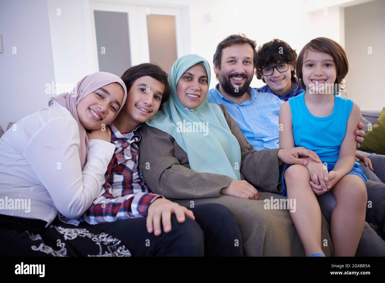 portrait de famille musulman avec des adolescents arabes à l'intérieur moderne de la maison Banque D'Images