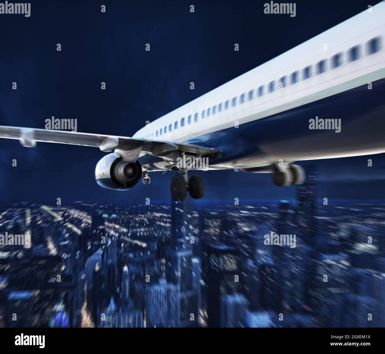 L'avion voyage la nuit dans une ville moderne Banque D'Images