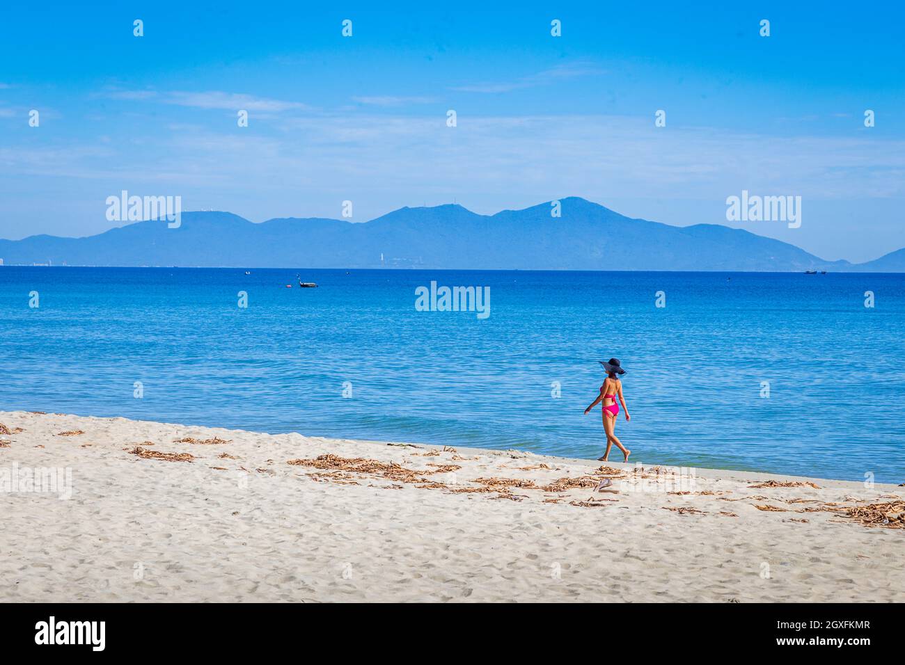 Fille en bikini rouge marchant sur la plage à anbang Beach, Vietnam Banque D'Images