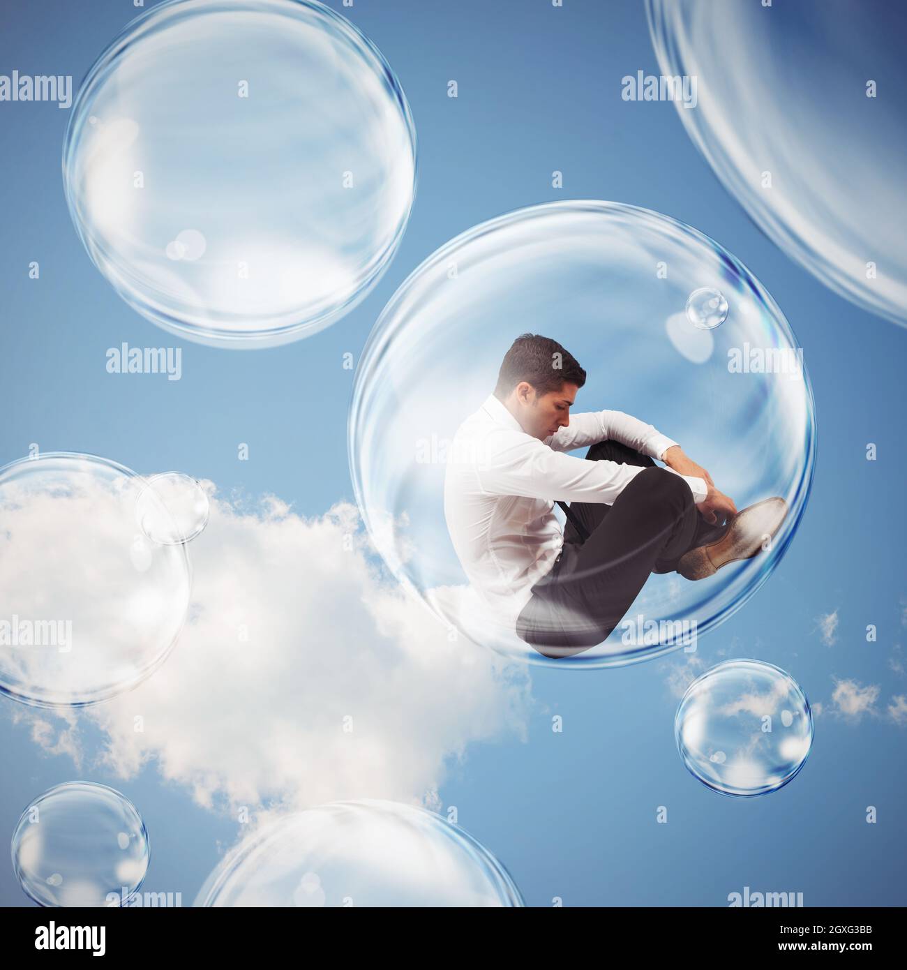 Un homme d'affaires triste vole dans une bulle et s'isole à l'intérieur d'une bulle du concept du monde extérieur Banque D'Images