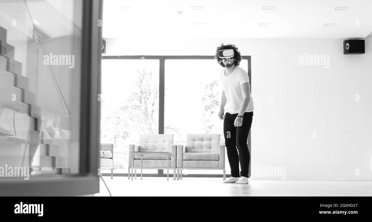 Homme heureux acquérir de l'expérience à l'aide de casque VR-verres de la réalité virtuelle à la maison Banque D'Images