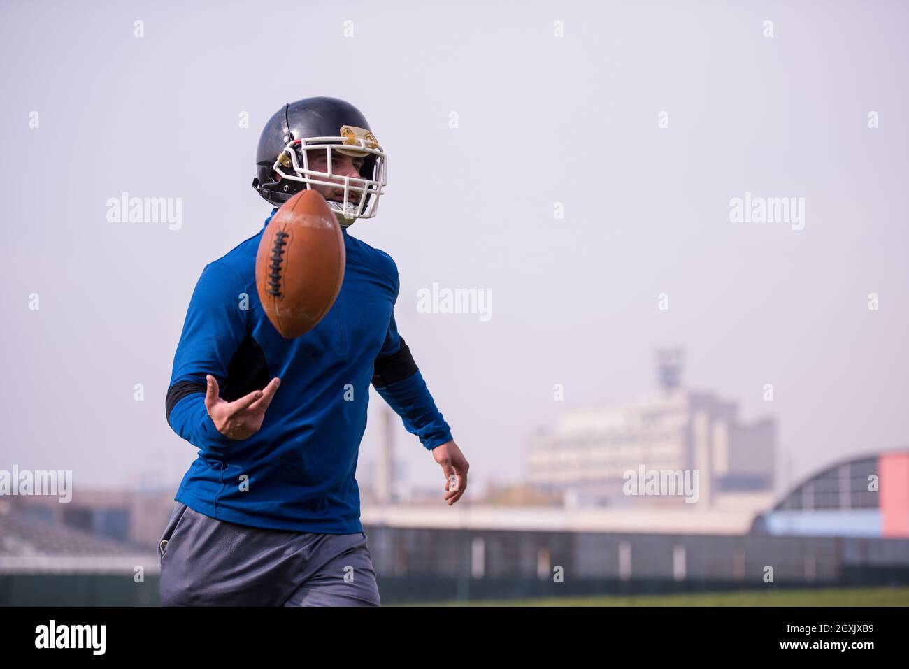 Jeune joueur de football américain en action au cours de la formation sur le terrain Banque D'Images