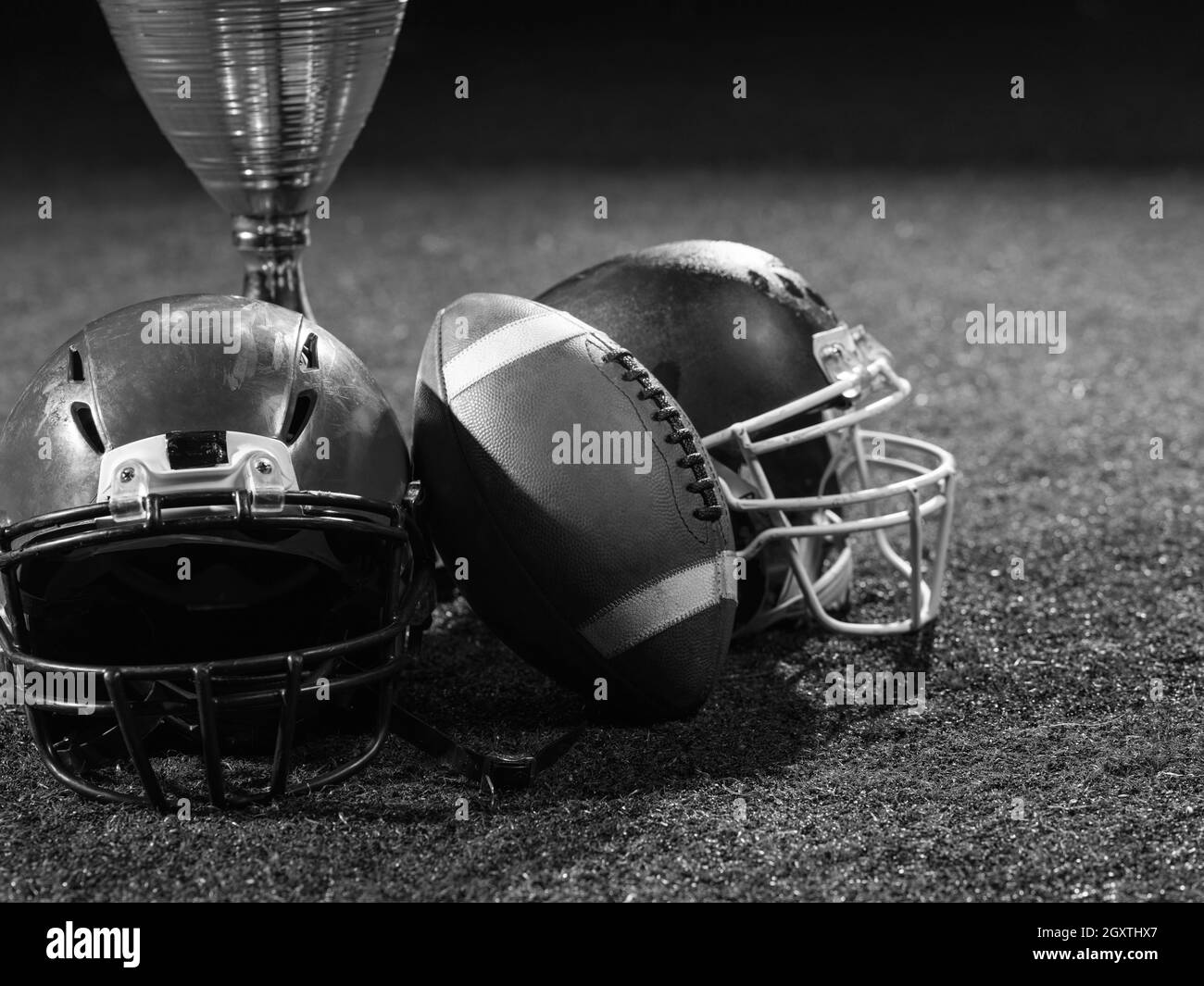 Libre shot du football américain,casques et trophy sur pelouse la nuit Banque D'Images