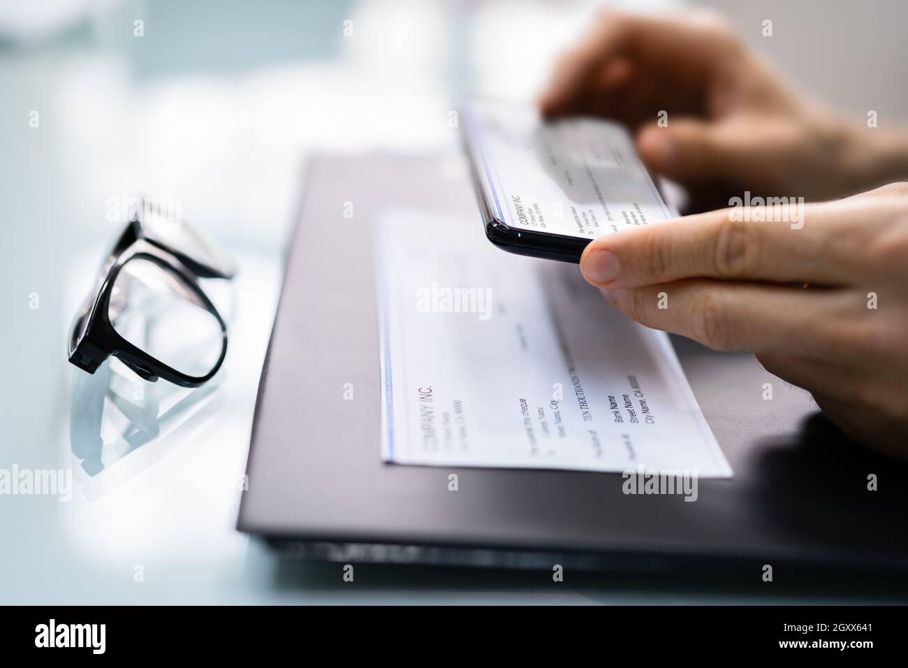 Prise d'une photo du document de vérification de la paie de dépôt à distance Banque D'Images