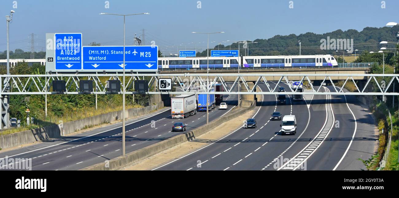 M25 autoroute porte-route panneau jonction 28 Brentwood Essex Elizabeth Line nouveau train de banlieue Crossrail à destination de Londres sur le pont ferroviaire Angleterre Royaume-Uni Banque D'Images