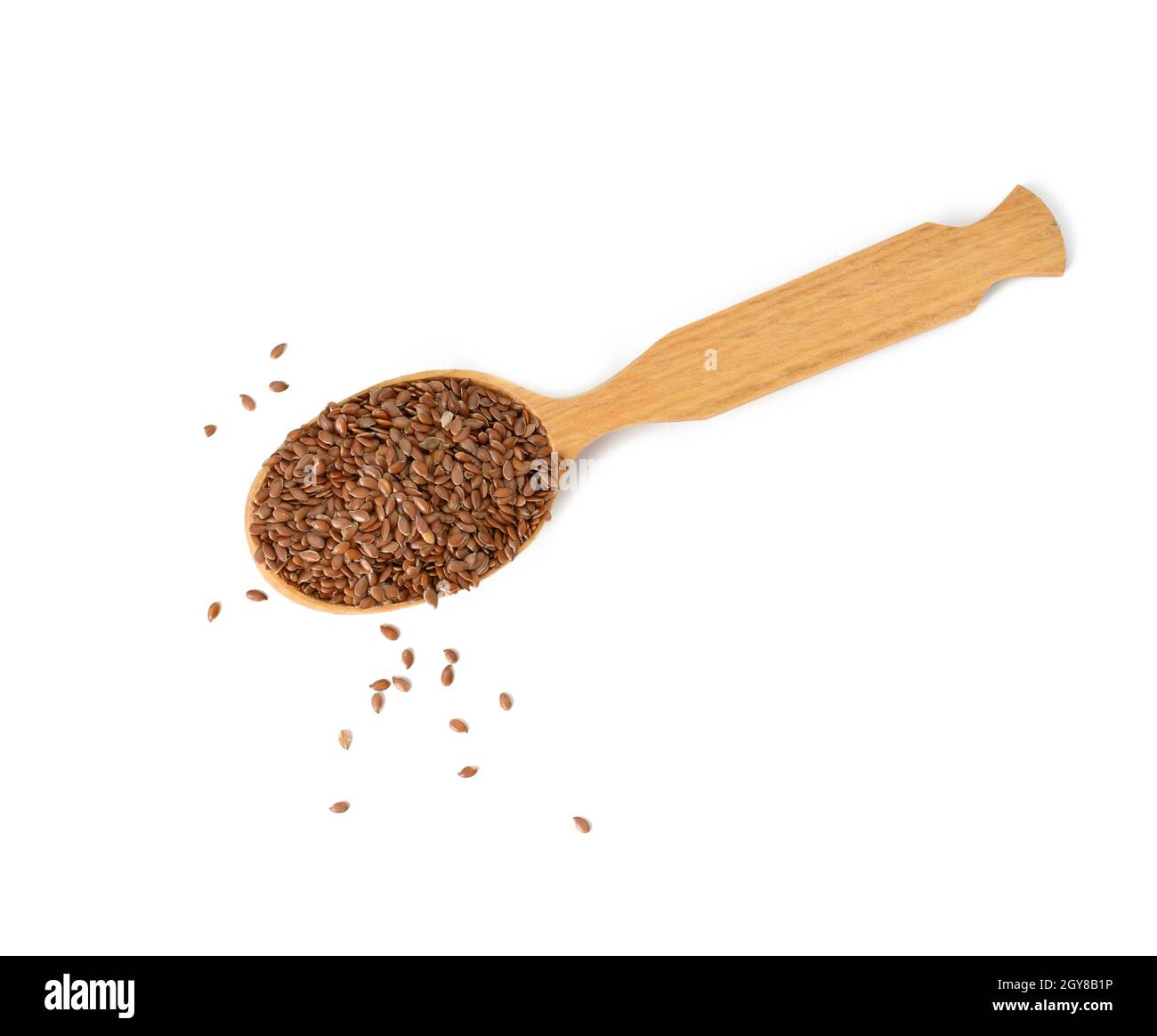 faire dorer les graines de lin sèches dans une cuillère en bois sur fond blanc, vue du dessus Banque D'Images