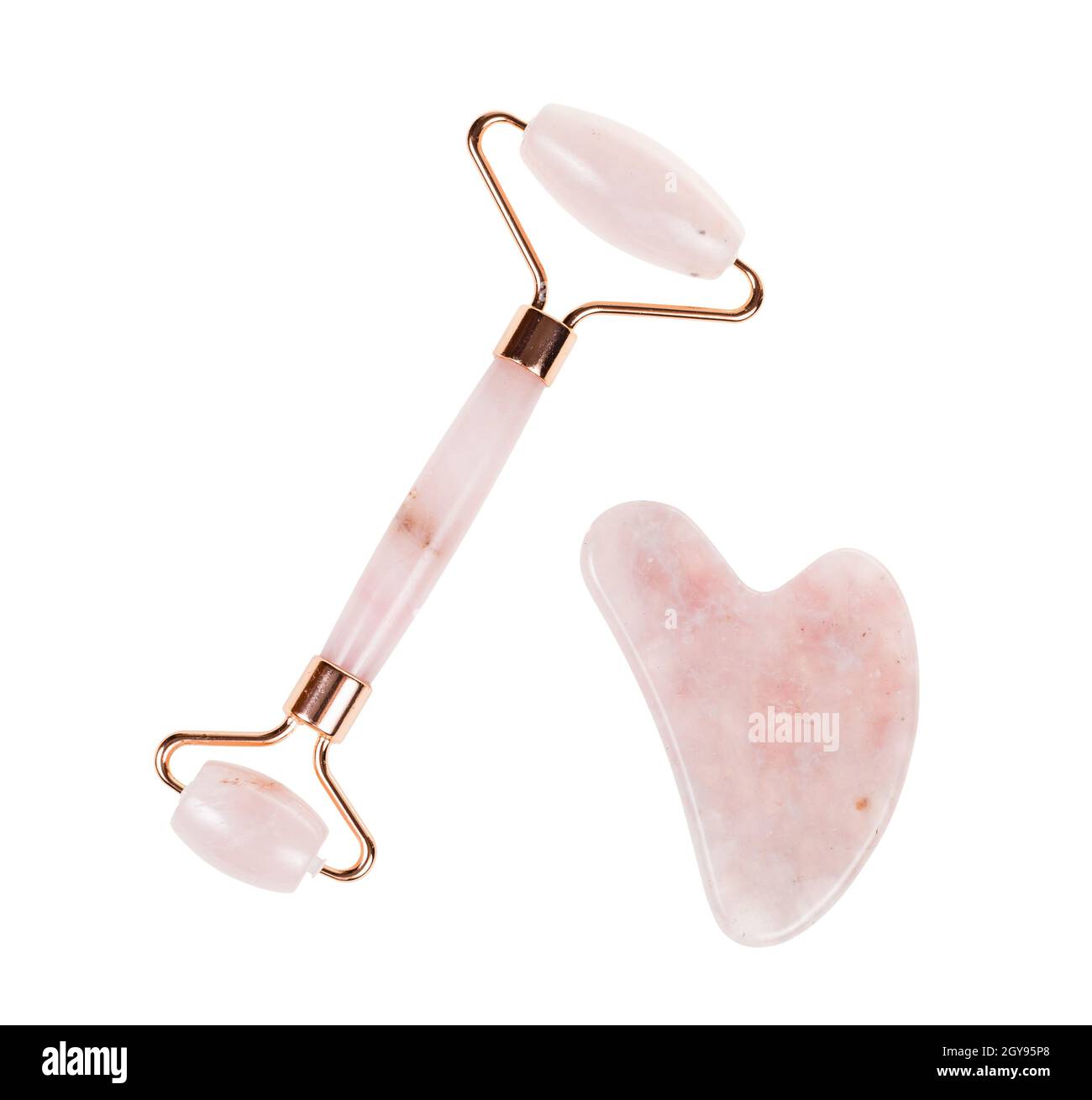 outils pour le massage du visage chinois traditionnel gua sha en pierre naturelle de quartz rose isolée sur fond blanc Banque D'Images