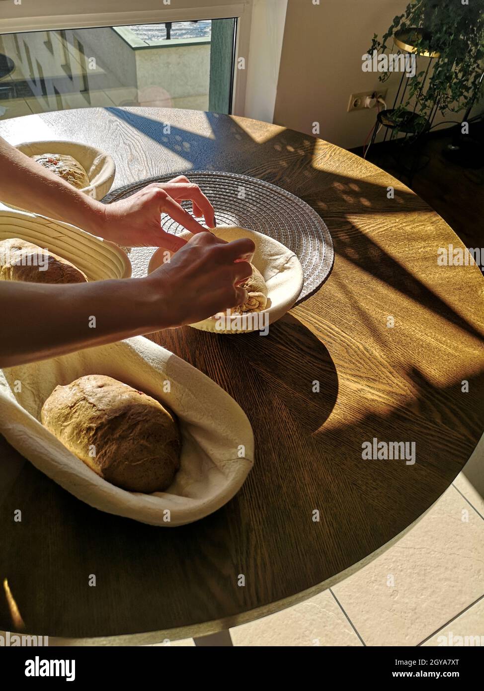 Le boulanger place la pâte de seigle sur la pâte à levain dans les paniers Banque D'Images