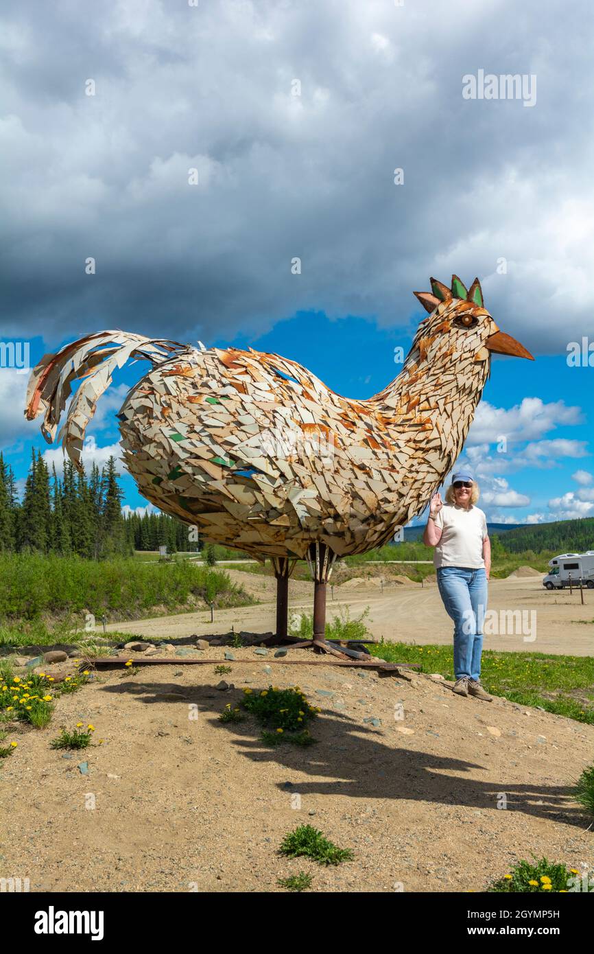 États-Unis, Alaska, poulet, sculpture métallique, visiteur féminin Banque D'Images