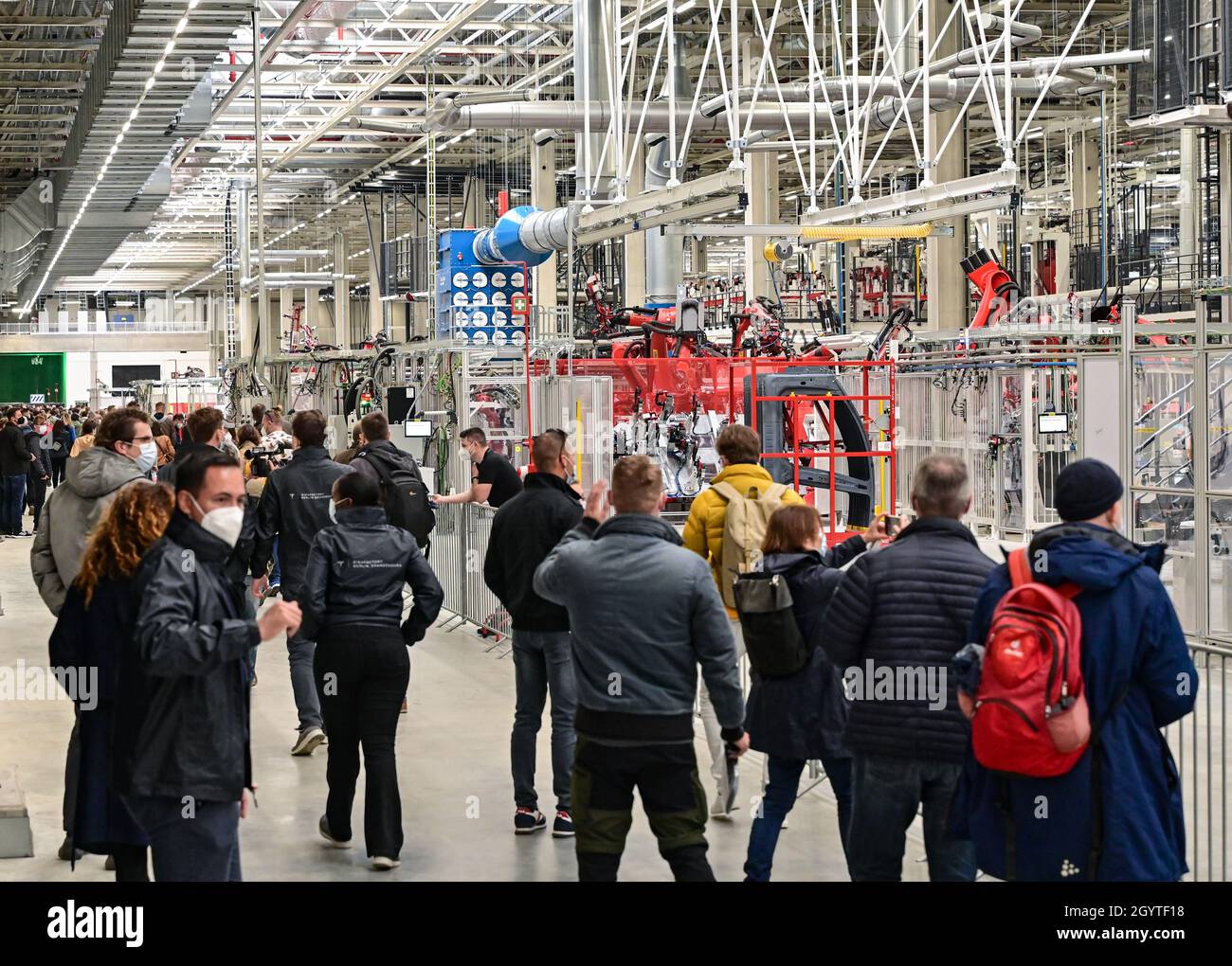 09 octobre 2021, Brandebourg, Grünheide : de nombreux visiteurs traversent la salle d'usine du Gigalactory de Tesla pendant la journée.À Grünheide, à l'est de Berlin, les premiers véhicules devraient sortir de la chaîne de production à partir de fin 2021.Des milliers de visiteurs devraient assister à la journée portes ouvertes sur le site de construction de la première usine européenne de Tesla, fabricant américain de voitures électriques, près de Berlin.Photo: Patrick Pleul/dpa-Zentralbild/dpa Banque D'Images