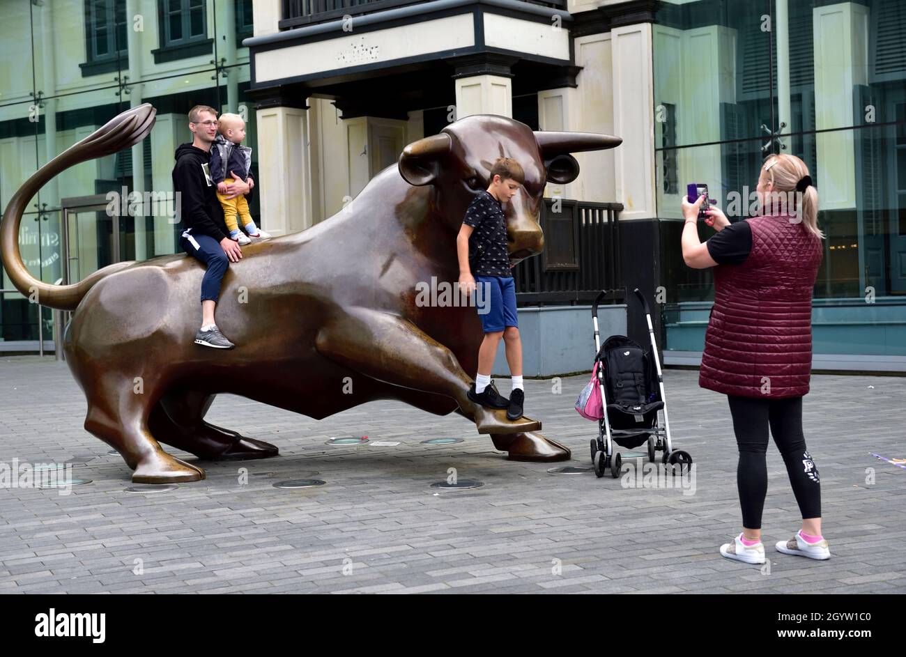 Sculpture de taureau à l'entrée du centre commercial Bullring avec escalade en famille sur la stature pour la photo Banque D'Images