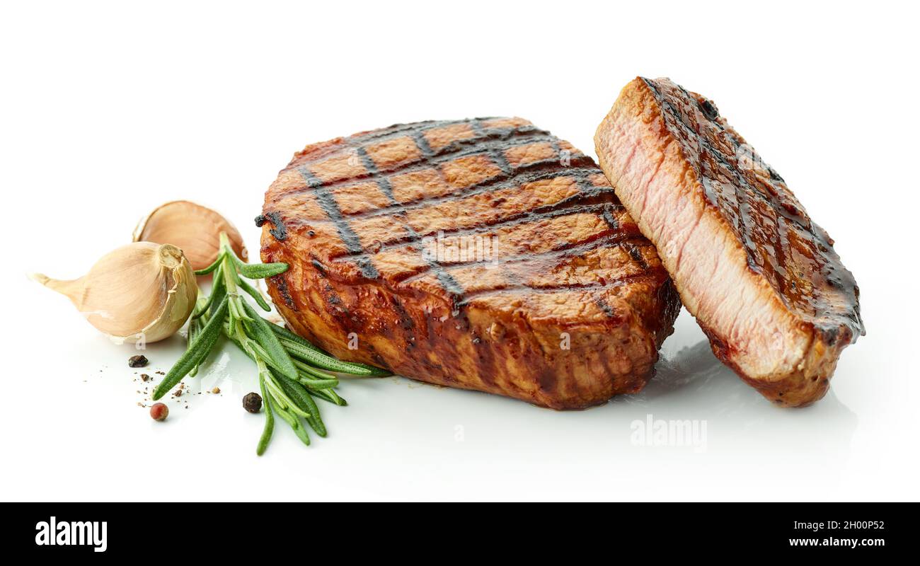 Filet de bœuf grillé, steak, romarin et ail isolés sur fond blanc Banque D'Images