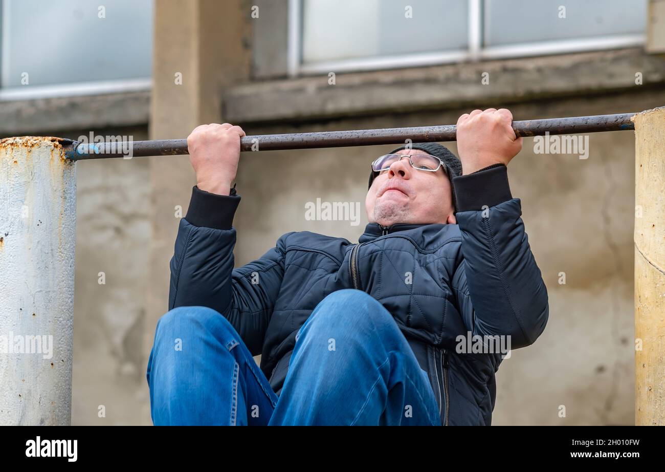 humour, un homme adulte tire sur une barre horizontale Banque D'Images