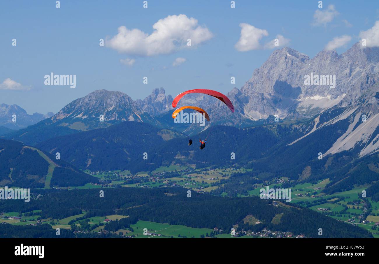 Deux amis parapente dans les Alpes de la région de Dachstein en Autriche Banque D'Images