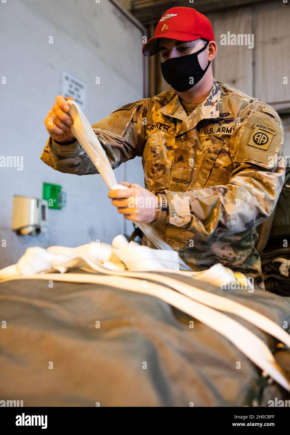 SPC.Michael Crockett, un régleur de parachute affecté au 151e Quartermaster Company, 189e Bataillon de soutien au combat, 82e Brigade de soutien de la Division aéroportée, prépare des parachutes pour fixation aux plates-formes de chute lourde à la base interarmées Charleston, S.C., 21 janvier 2021.Les plates-formes à forte chute étaient en préparation pour une prochaine rotation du centre de formation joint Readiness. Banque D'Images