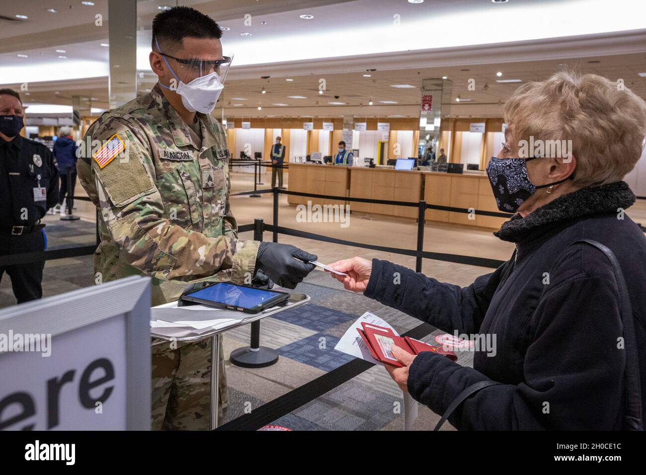 Un soldat de l'armée américaine de la 44e équipe de combat de la Brigade d'infanterie, de la Garde nationale de l'armée du New Jersey, retourne une carte de code de réponse rapide après l'avoir scannée au méga-site de vaccination du comté de Burlington récemment ouvert COVID-19, Moorestown, N.J., 22 janvier 2021.Les citoyens-soldats participent au contrôle de la température, à la saisie des informations d'assurance, au guidage des individus dans les différents postes et au suivi des personnes après qu'elles aient reçu leur vaccination.(New Jersey Banque D'Images