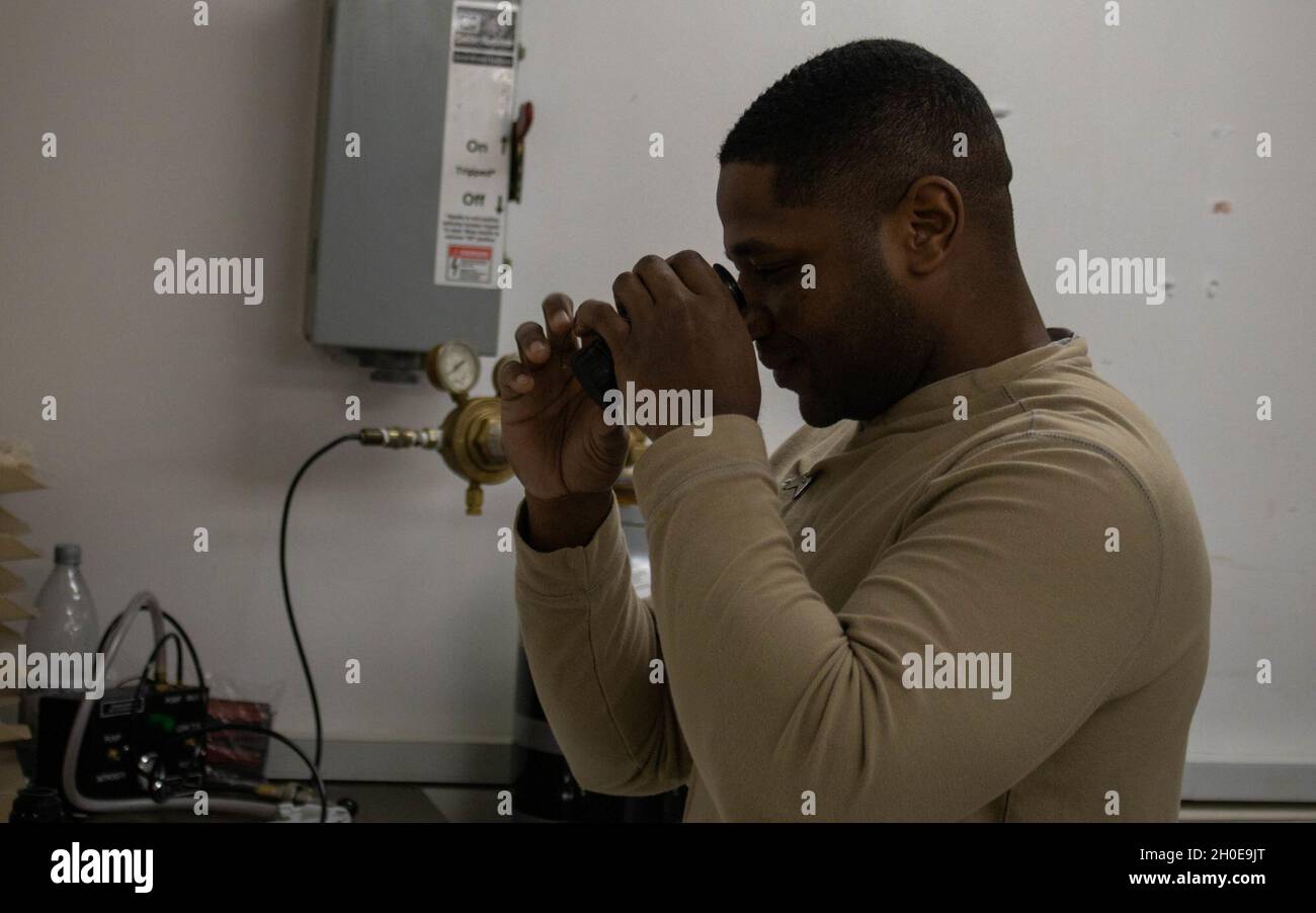 SPC de l'armée américaine.Dyami Stanley, un armateur de la 317e Compagnie de maintenance de soutien, 18e Brigade de soutien de combat, 16e Brigade de soutien, de Baumholder, Allemagne, inspecte un M68 Close combat Optics lors d'une inspection annuelle des armes au Camp Bondsteel, Kosovo, le 9 février 2021.Les accessoires d'armes comme les COC nécessitent des inspections d'entretien annuelles. Banque D'Images