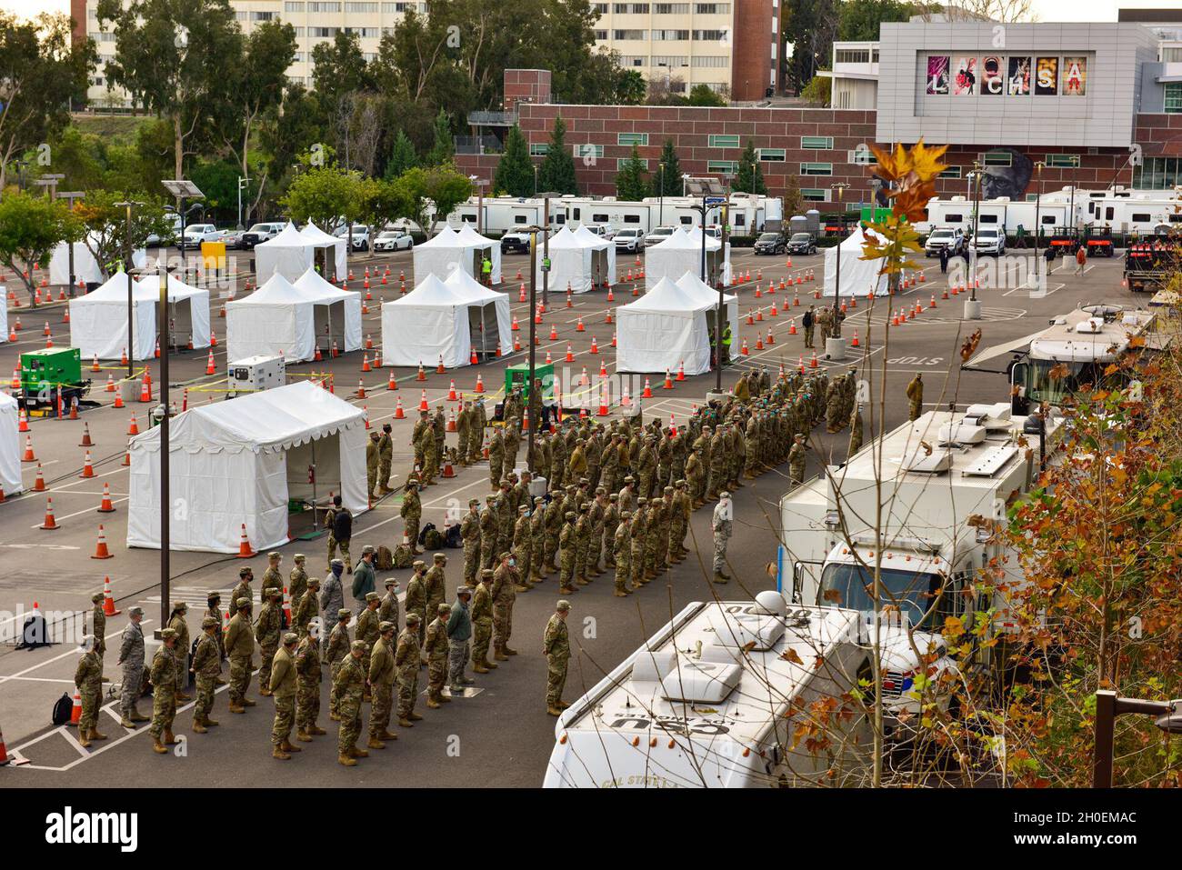 Des gardiens de la Garde nationale de Californie affectés à la Force opérationnelle interarmées Mustang assistent à un briefing du matin sur le campus de l'Université d'État de Californie à Los Angeles, le 15 février 2021.La force a été mise en service pour soutenir le premier site de distribution du vaccin COVID-19 de l’Agence fédérale de gestion des urgences et du Bureau des services d’urgence du gouverneur de la Californie. Banque D'Images