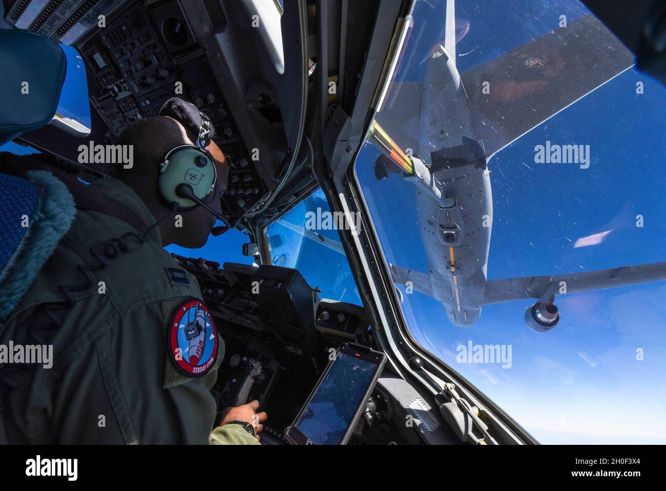 Le capitaine Wesley Cobb, pilote du 4e Escadron de transport aérien, effectue un ravitaillement en vol depuis un KC-46 de la base aérienne McConnel, Kansas, le 20 février 2021.Le ravitaillement aérien permet une plus grande mobilité et des temps de vol plus rapides parce qu'un avion n'a pas à atterrir pour faire le plein. Banque D'Images