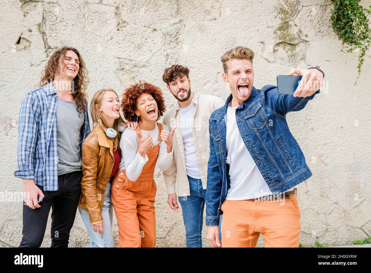 Des jeunes heureux prenant le selfie dans la ville - groupe multiracial d'amis prend une photo regardant l'appareil photo Banque D'Images