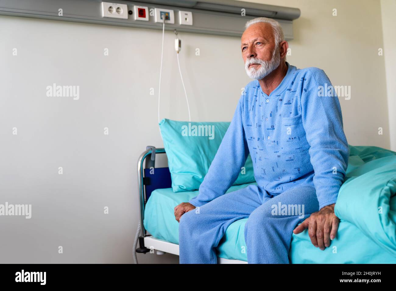 Patient masculin âgé dans le lit d'hôpital qui se remet de la maladie. Concept de soins de santé. Banque D'Images