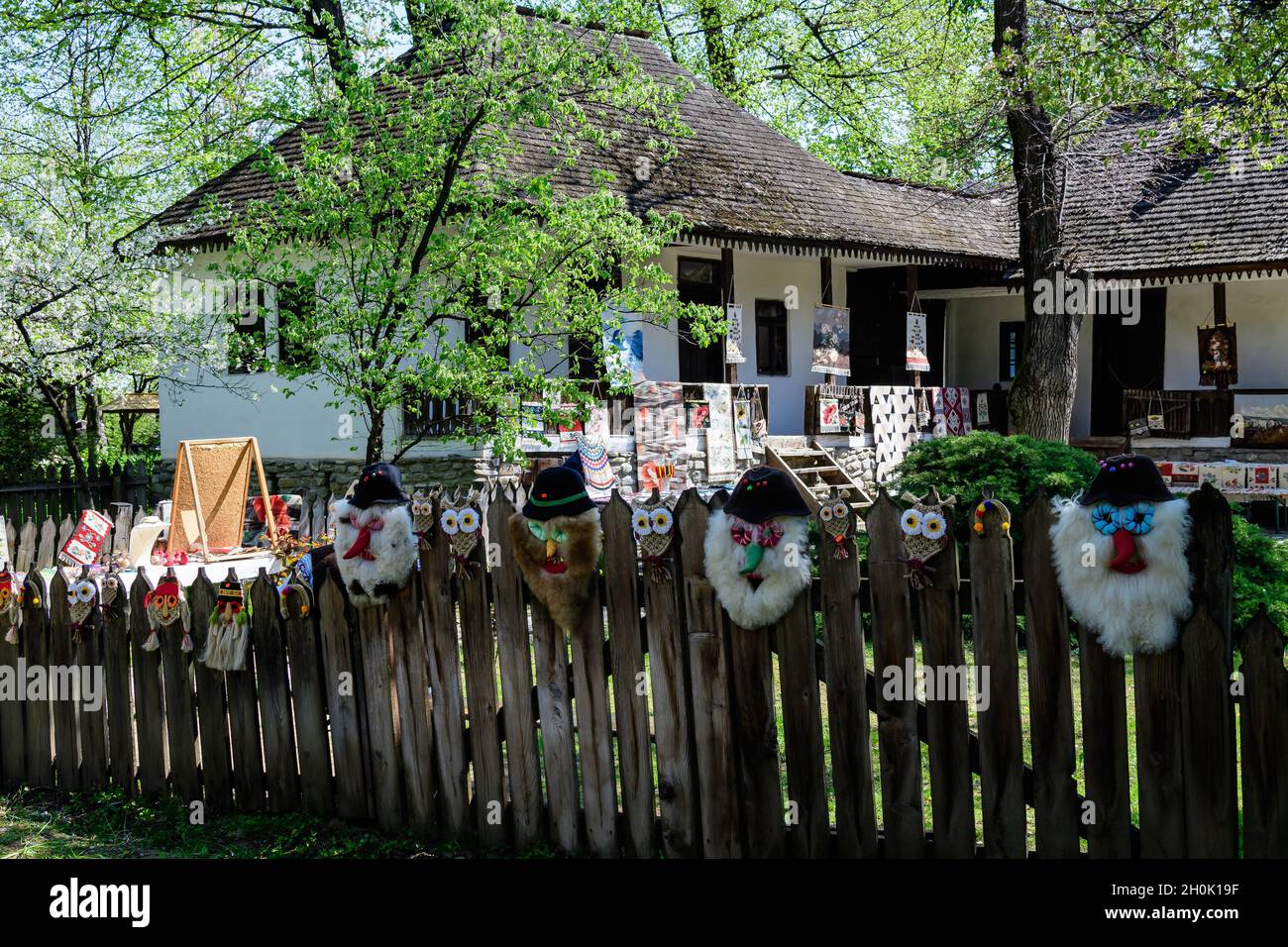 Bucarest, Roumanie - 25 avril 2021 : ancienne maison roumaine traditionnelle survolée avec de nombreux vieux arbres et de l'herbe verte dans le village national de Dimitrie Gusti Mu Banque D'Images