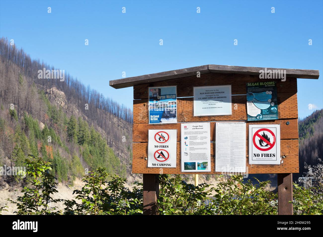 Un panneau à l'entrée du barrage de Cougar, avec des avertissements d'incendie, avec une colline brûlée derrière, endommagé par l'incendie de vacances 2020. Banque D'Images