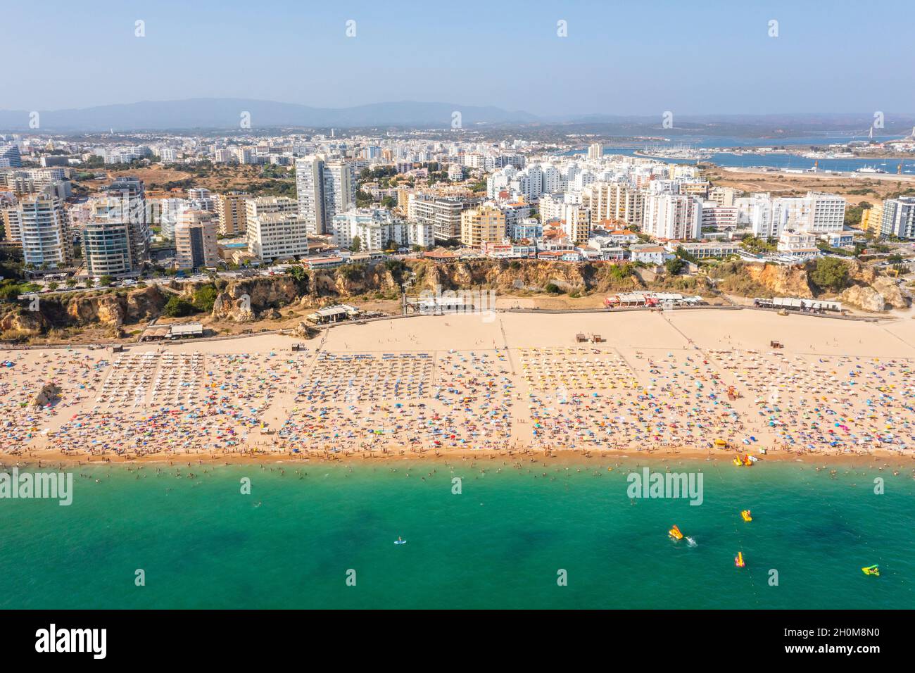 Vue aérienne de Portimao touristique avec une large plage de sable de Rocha pleine de gens, Algarve, Portugal Banque D'Images
