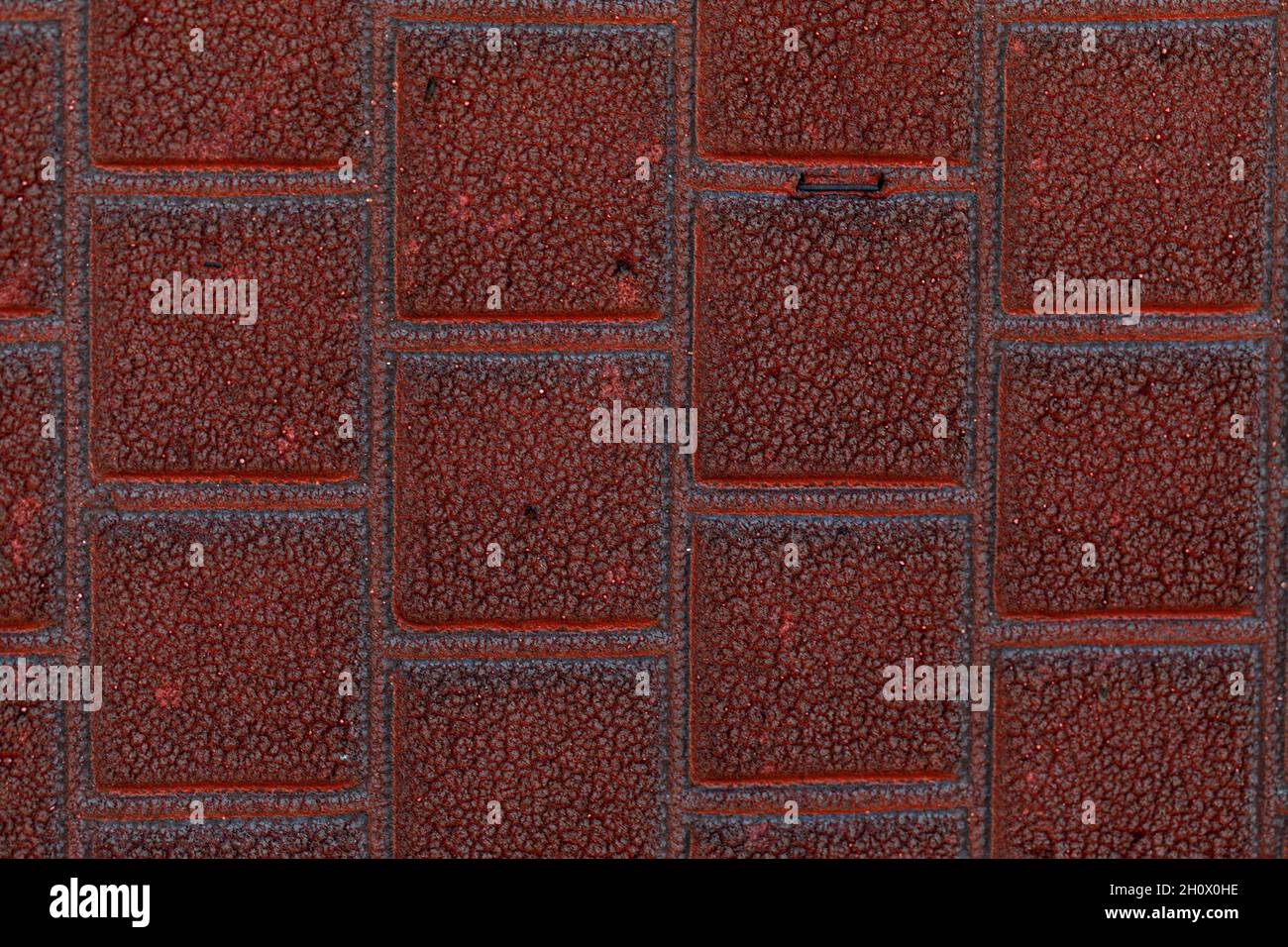 arrière-plan carré en pierre rouge.Textures rugueuses d'un matériau de construction. Texture de mur de brique Banque D'Images