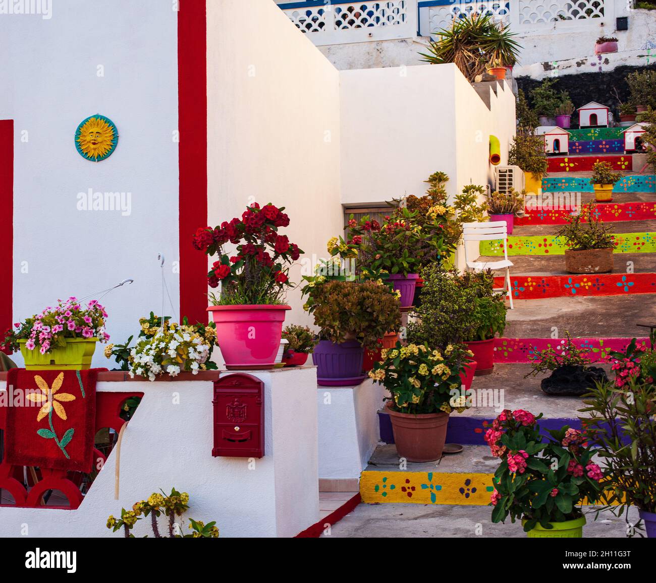 Vue sur une maison de couleur typique à Linosa avec l'escalier plein de pots de fleurs Banque D'Images Vue sur une maison de couleur typique à Linosa avec l'escalier plein de pots de fleurs Banque D'Images