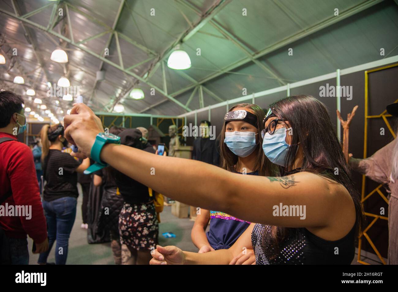 Les gens prennent des photos et des selfies avec les sculptures des personnages de films d'horreur pendant le premier jour du SOFA (salon del Ocio y la Fantasia) 2021, une foire destinée au public geek en Colombie qui mélange Cosplay, jeux, super héros et fans de cinéma de toute la Colombie, à Bogota,Colombie le 14 octobre 2021. Banque D'Images