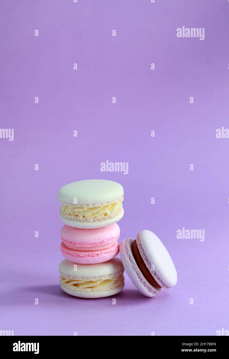 Macaron ou macaron sur fond lilas, biscuits aux amandes colorés avec différentes garnitures Banque D'Images