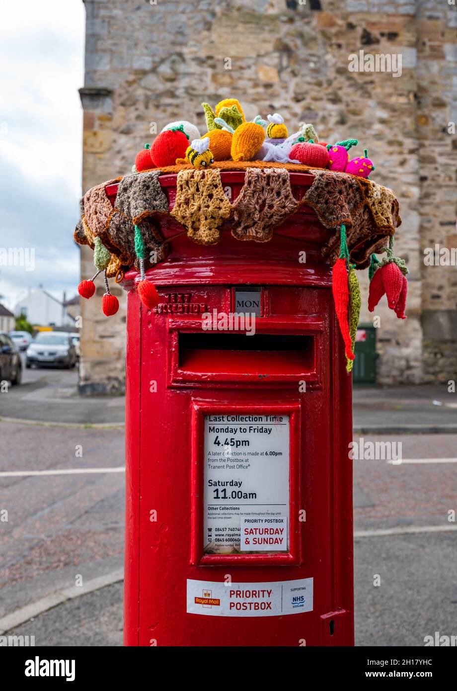 Décoration de récolte en bonneterie sur la boîte postale Royal Mail, bureau de poste du village d'Ormiston, East Lothian, Écosse, Royaume-Uni Banque D'Images