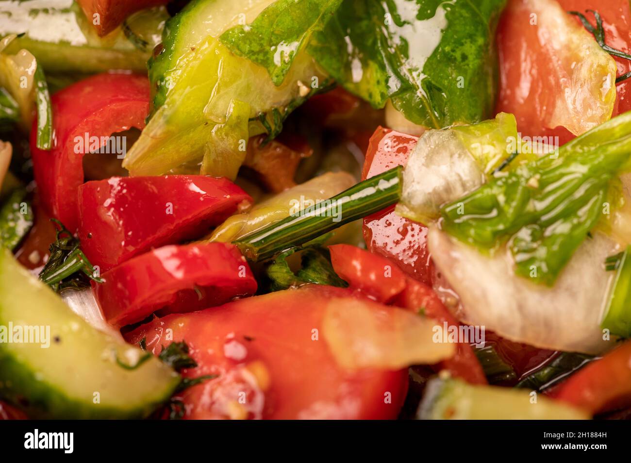 Salade de légumes en tranches de tomates, concombres, poivrons, radis et herbes, gros plan, mise au point sélective Banque D'Images