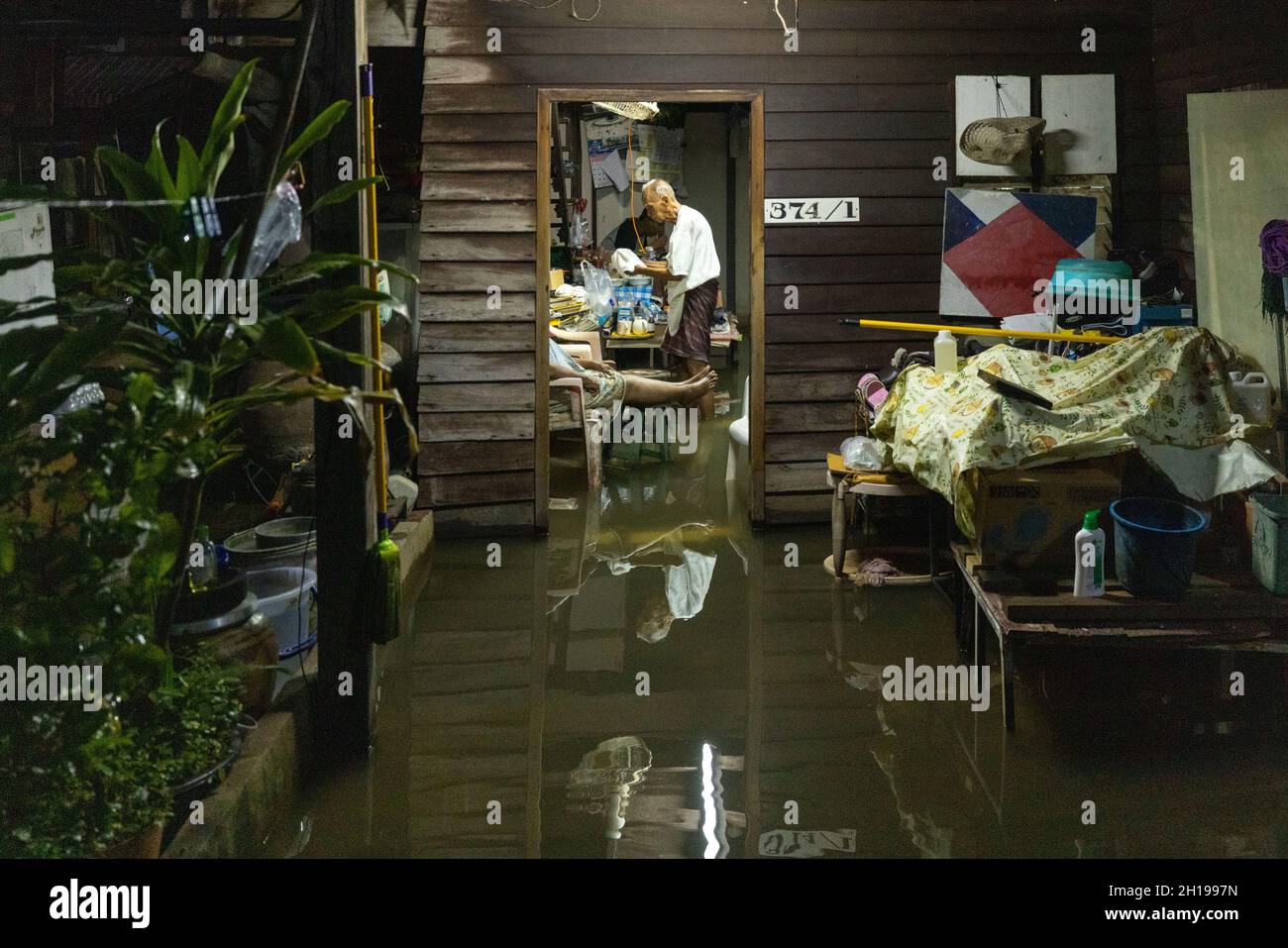 Bangkok, Thaïlande.17 octobre 2021.Les résidents sont vus dans leur maison submergée après de fortes inondations dans la communauté de Santichon Songkroh.la communauté de Santichon Songkroh, une petite communauté le long du canal de Bangkok Noi, fait maintenant face à des inondations quotidiennes provoquées par les fuites de murs d'eau et les fortes précipitations de la tempête tropicale Kompasu.Crédit : SOPA Images Limited/Alamy Live News Banque D'Images
