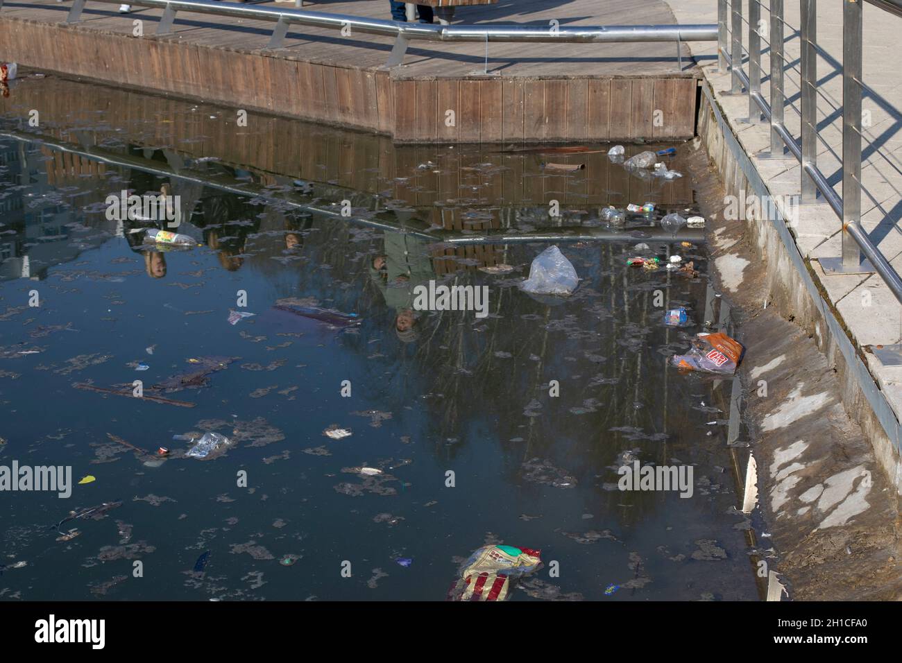 Vidnoe, Russie - 11 avril 2021 : pollution de l'étang de la ville après les vacances, beaucoup d'emballages de bouteilles flottent sur la surface de l'étang Banque D'Images