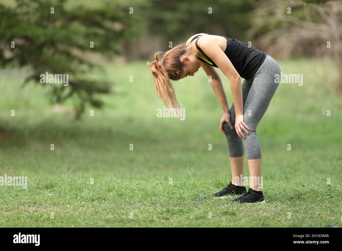 Coureur épuisé se tenant debout dans un parc Banque D'Images