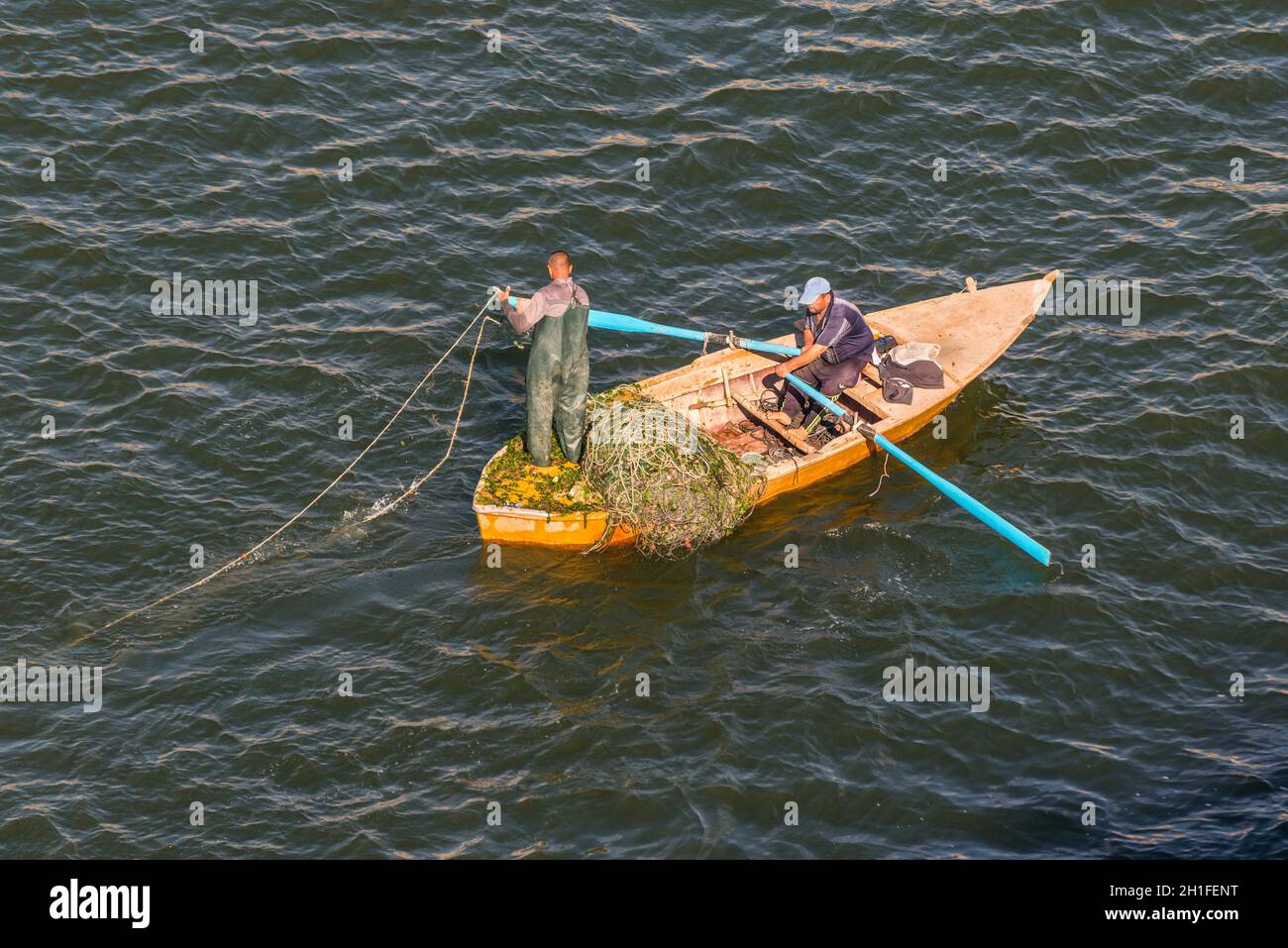 Ismailia, Egypte - Novembre 5, 2017 : les pêcheurs en bateau en bois prendre du poisson sur le net nouveau canal de Suez, Ismaïlia, Egypte, l'Afrique. Banque D'Images