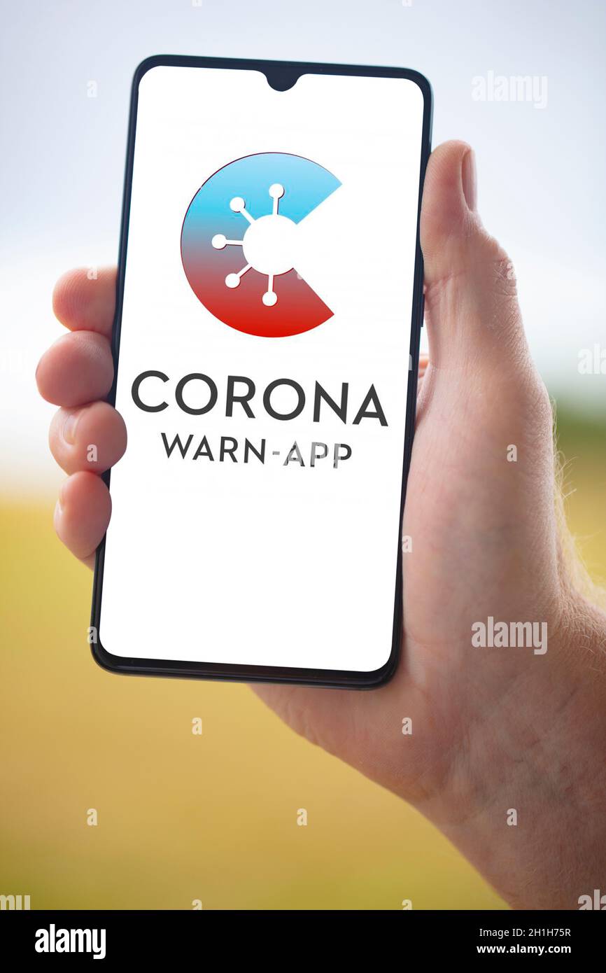 WETZLAR; ALLEMAGNE 2020-08-26, CORONA APPLICATION officielle allemande Corona Warning App sur téléphone portable tenu à la main sur fond flou Banque D'Images