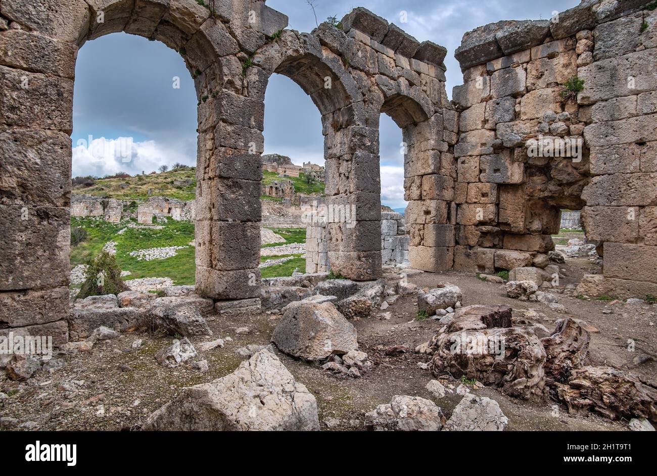 Ruines de Tlos, ancienne citadelle lycienne au sommet d'une colline près de la station de Seydykemer dans la province de Mugla, dans le sud de la Turquie.Vue sur l'Acropole par l'arche Banque D'Images