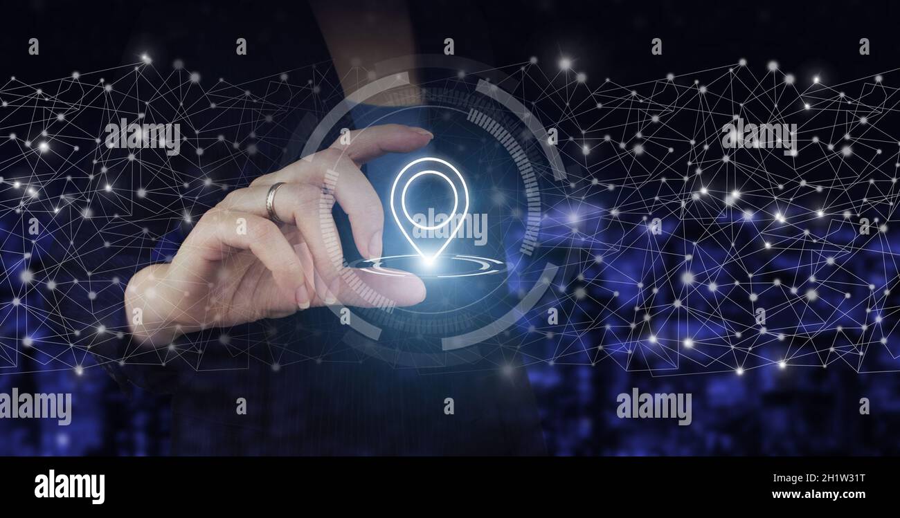 Concept de navigation.Concept de carte et d'innovation.Main tenir l'hologramme numérique emplacement marqueur sur ville sombre arrière-plan flou.Carte GPS, adresse PIN Banque D'Images