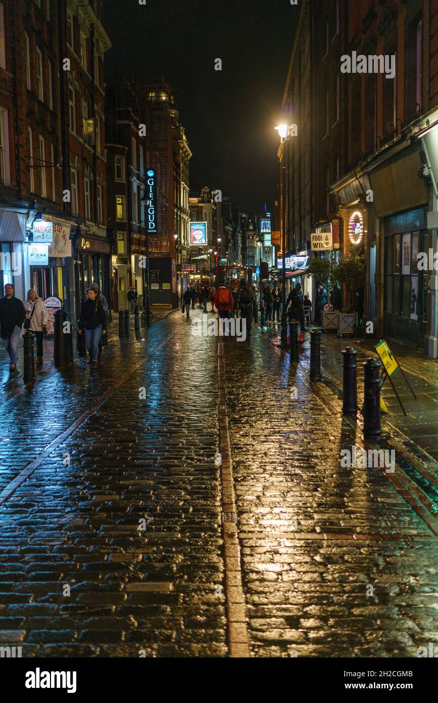 Photographie de rue montrant les rues humides de Soho à Londres la nuit Banque D'Images